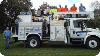 Stoughton Utilities staff gathers by their plug-in hybrid electric utility line truck.
